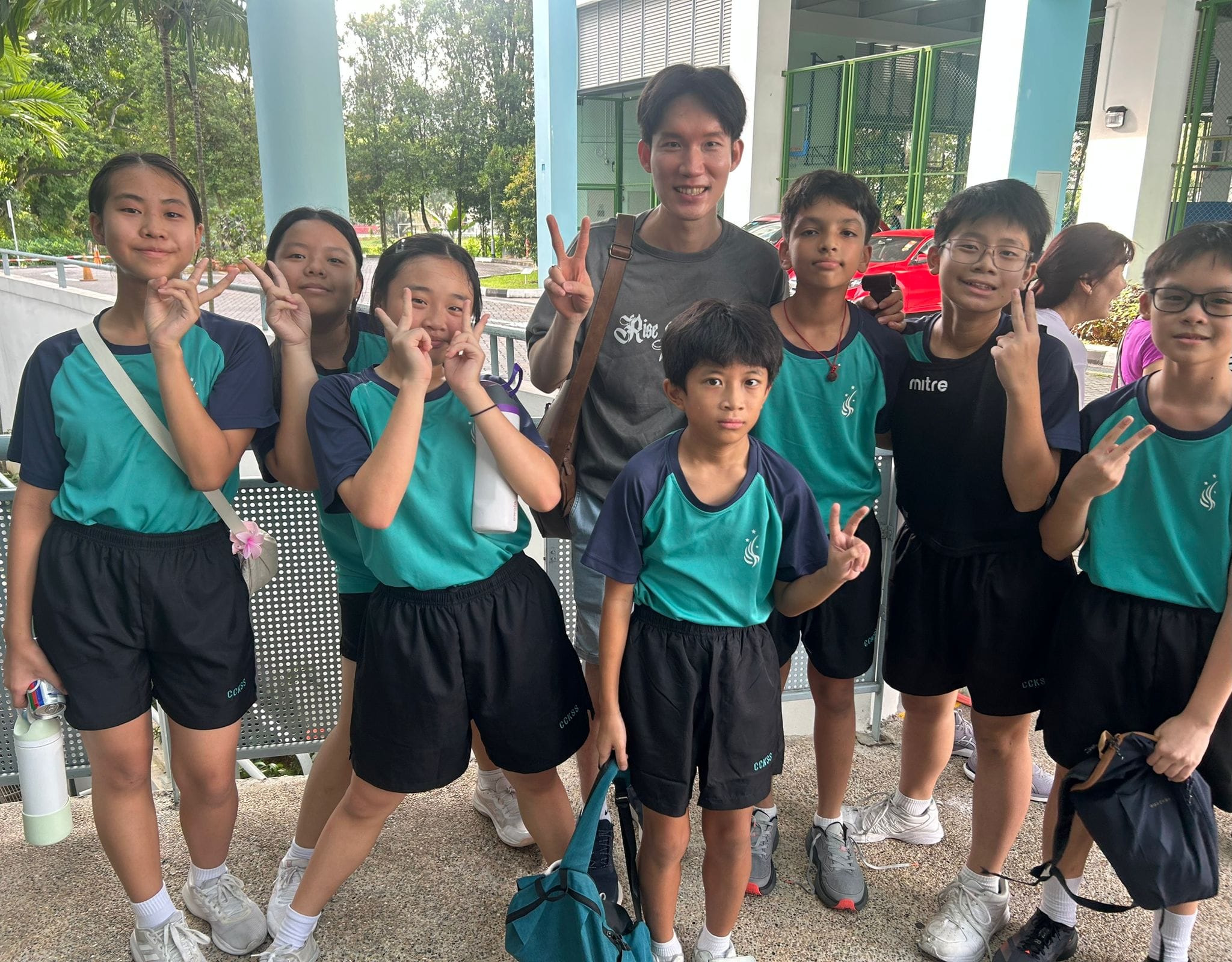 students pose with their teacher